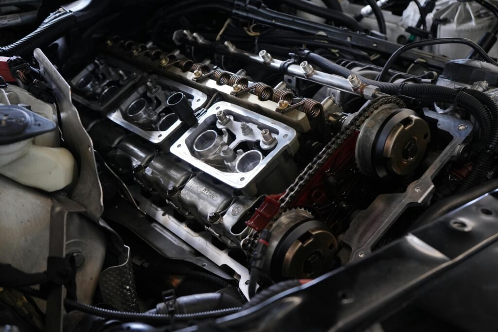 pexels-photo-28852335-28852335 Detailed view of car engine undergoing repair, showcasing intricate mechanical parts.