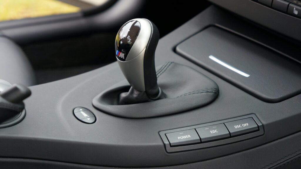 Detailed view of a car gear shift lever inside a luxury vehicle interior.